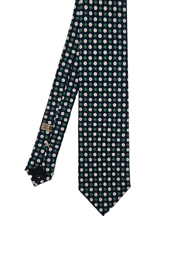 Cravatta in seta stampata blu con pattern floreale verde e bianco