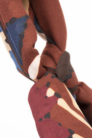brown, red, blue detail on a knot on a scarf