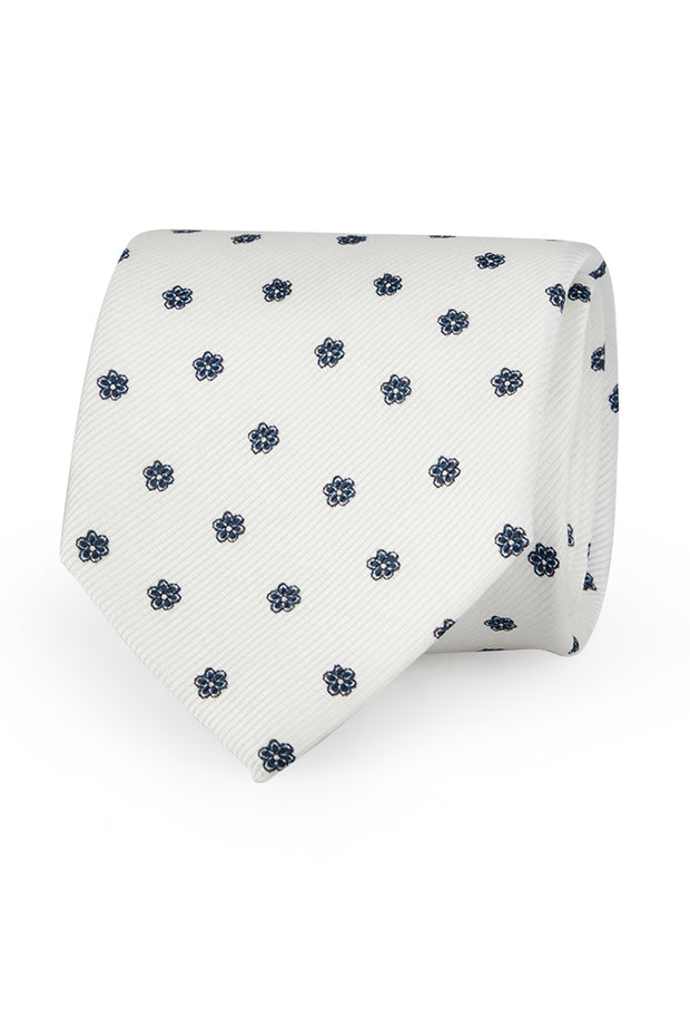 Cravatta  in seta stampata bianca con piccolo pattern classico blu 