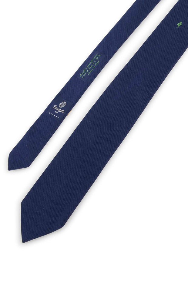 Blue silk tie with four-leaf clover under the knot