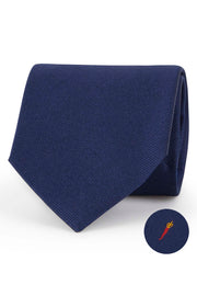 Blue silk tie with luck amulet under the knot