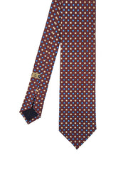 Cravatta in seta stampata rosso mattone con micro pattern floreale bianco azzurro