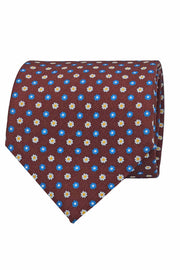 Cravatta in seta stampata rosso mattone con micro pattern floreale bianco azzurro