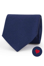 Blue silk tie with little red heart under the knot
