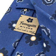 detail of fumagalli 1891 logo on the back of a blue italian tie
