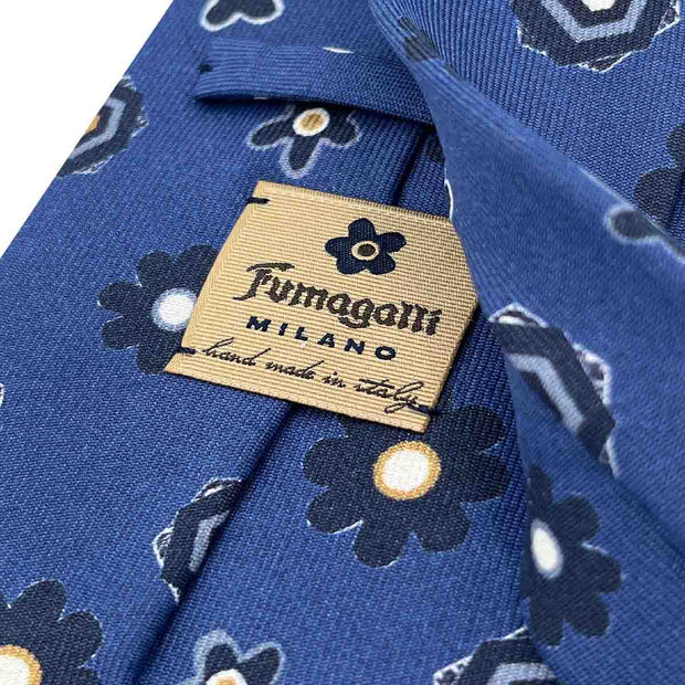 detail of fumagalli 1891 logo on the back of a blue italian tie
