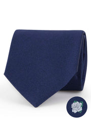 Blue silk tie with gardenia under the knot