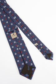 detail of a handmade in italy tie with flower- dettaglio di una cravatta fatta a mano in italia con fiori bianchi e blu