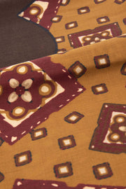 the medallion details and part of the big brown flower in the middle of the scarf