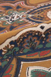 the detail of the wool and silk texture with in the frontground a paisley design 