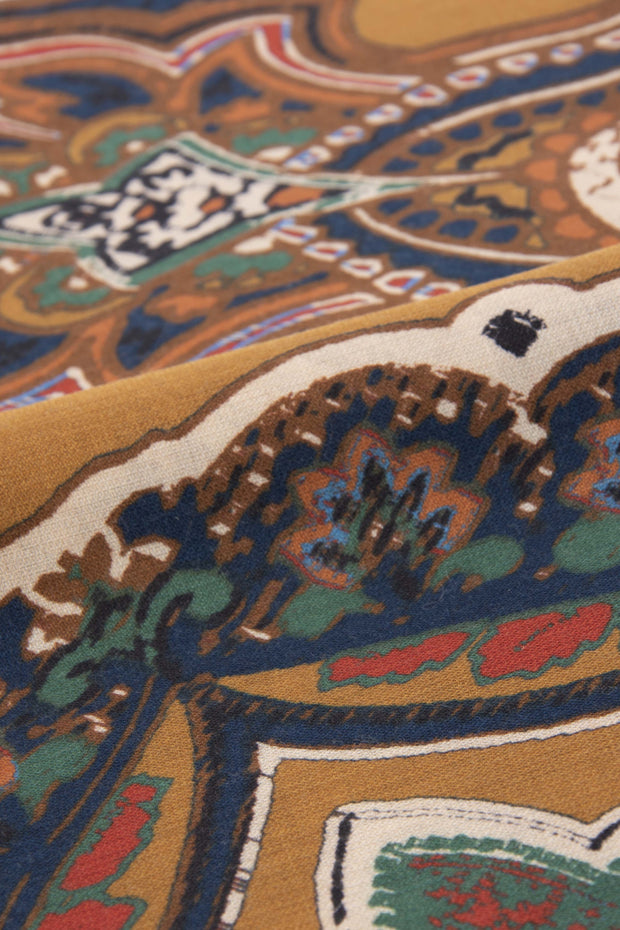 the detail of the wool and silk texture with in the frontground a paisley design 