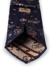 handmade pjacquard tie with little paisley and diamonds on a blue background