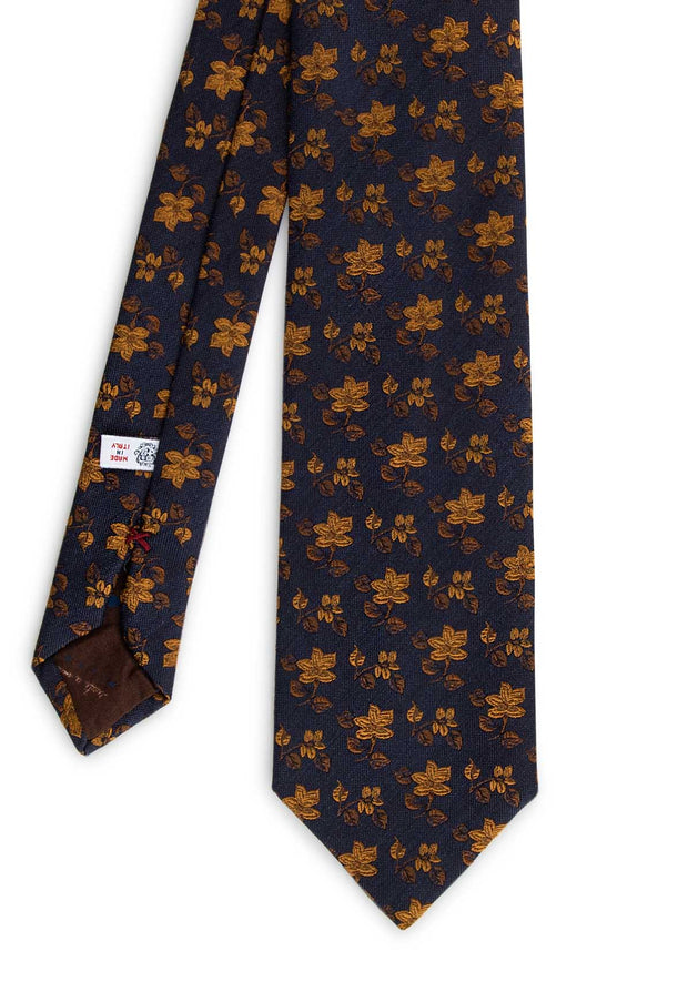 front vision of the hand made tie on a dark blue background on yellow gold floral