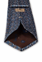back of the tie with sand brown fumagalli's label and the brown lining with fumagalli logo